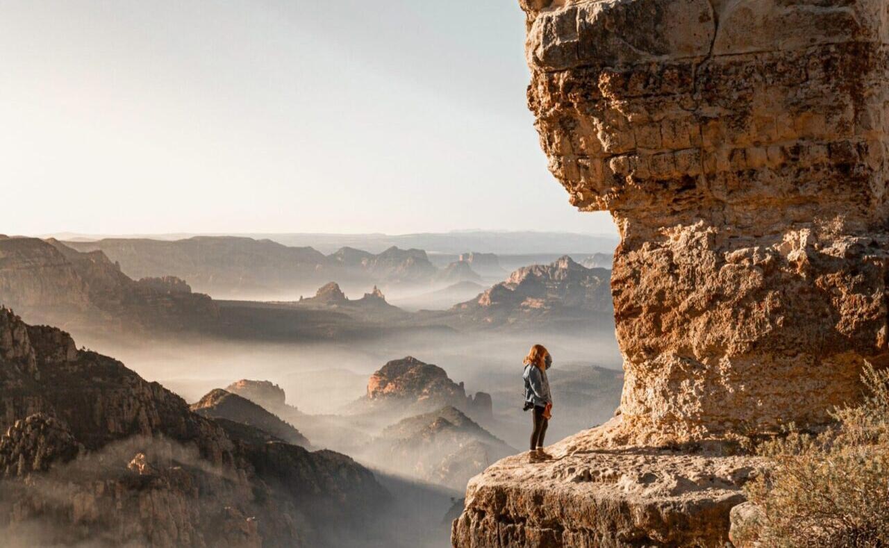 girl-standing-on-brown-rock-formation